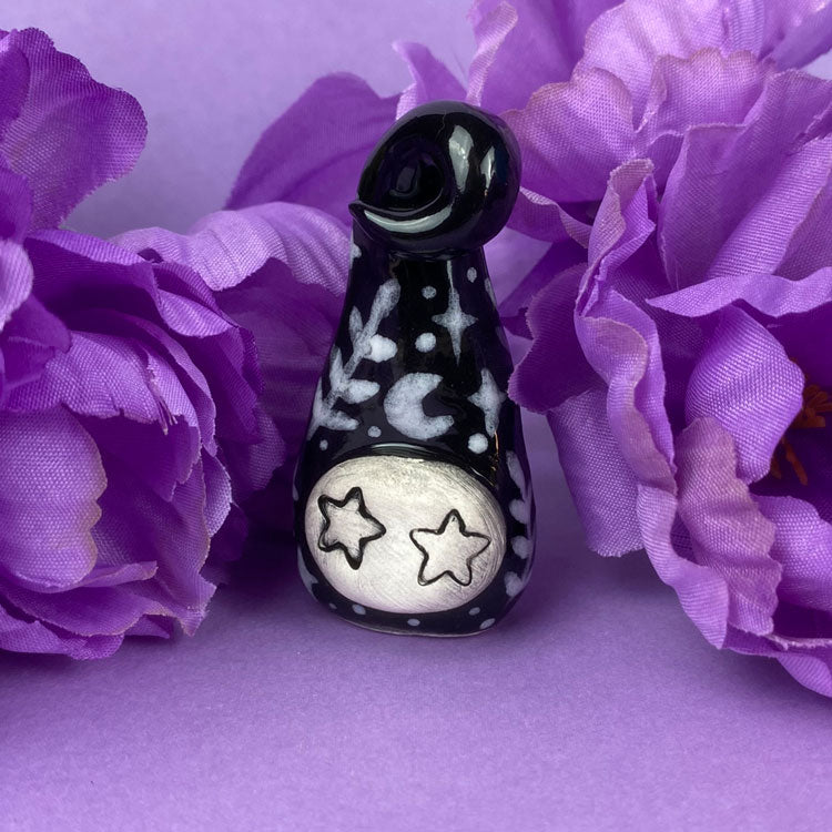 Photo of the handmade clay figures black starburst available in Politely Declining shop